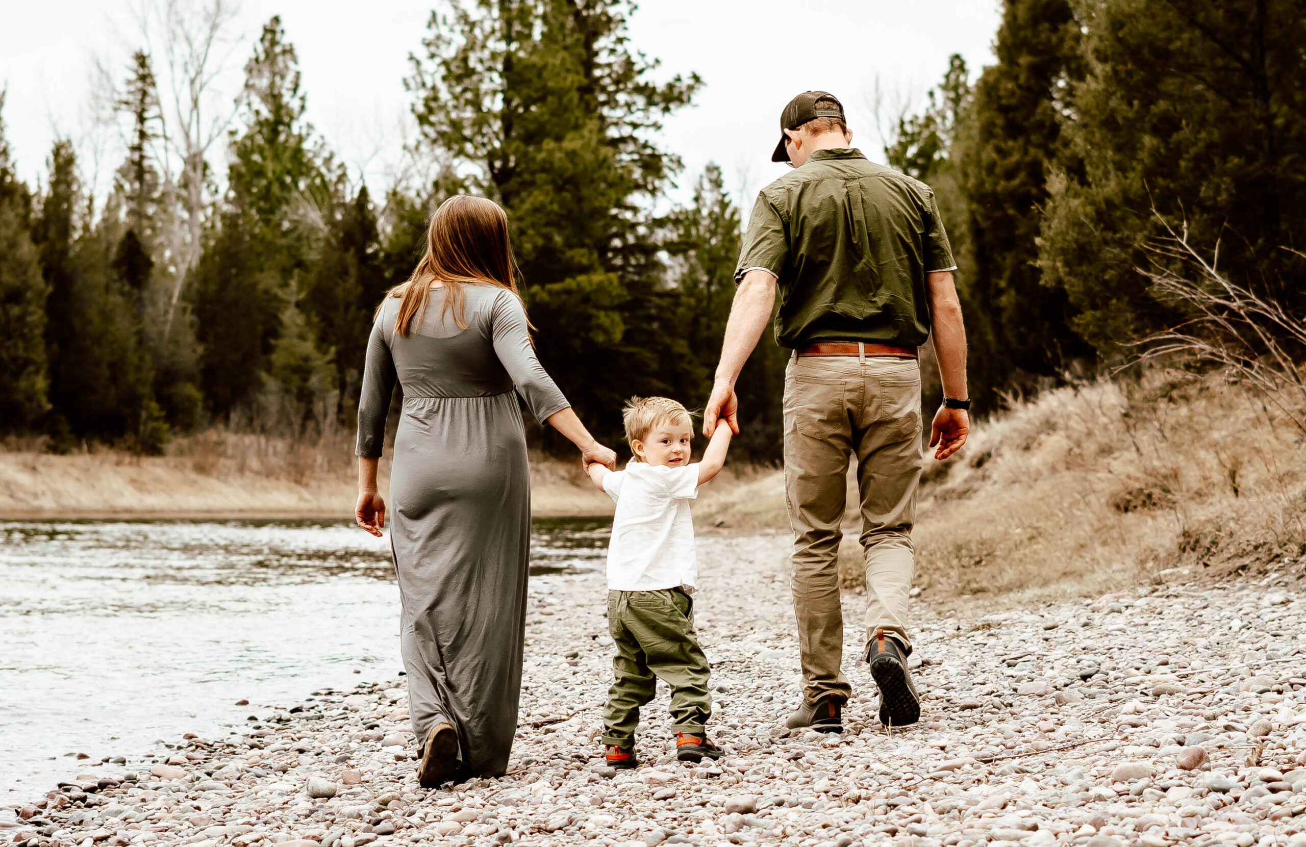 Family walking along the river during Adventure Maternity Session.