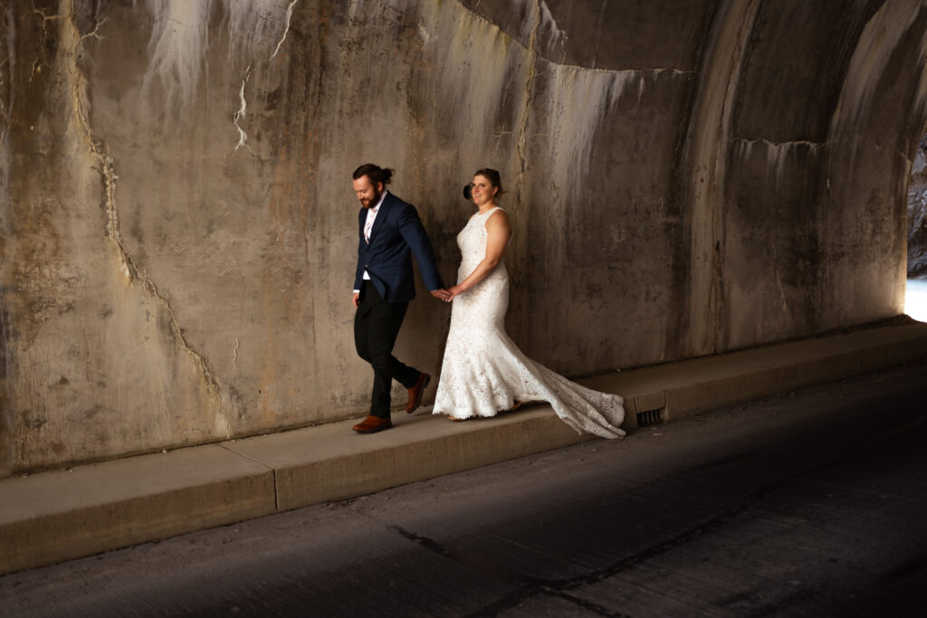 Bride and groom in tunnel of Glacier National Park